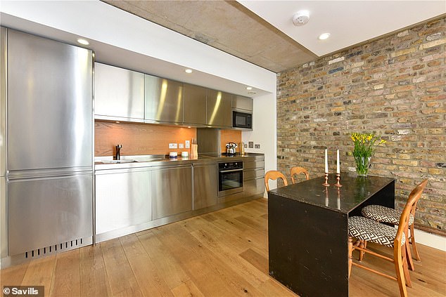 This flat in the Henson Building has some sleek finishes including the steel kitchen