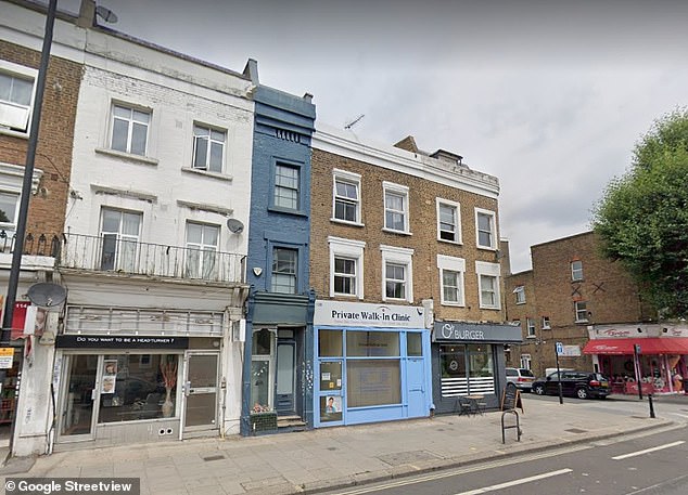 The facade, situated between a nail salon and a pizza restaurant, is painted blue and the unusual property offers 1,034 sq ft and two bedrooms