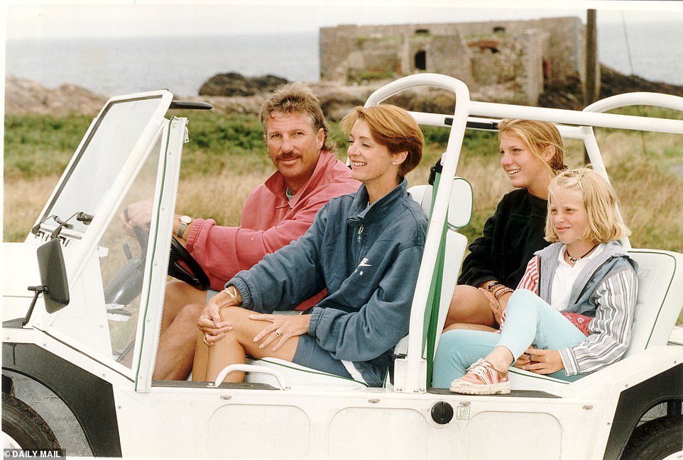 Former cricketer Sir Ian Botham pictured in 2007 in a Mini Moke with his wife Kathy and daughters