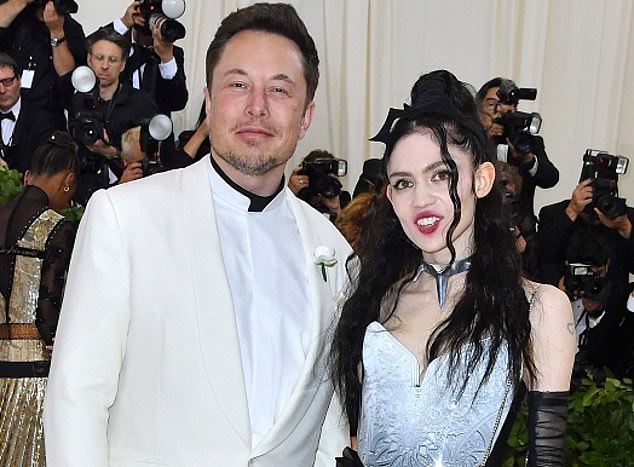 Facing the music: Tesla boss Elon Musk pictured with singer-songwriter girlfriend Grimes, admitted his company had not yet made the necessary breakthroughs in battery technology