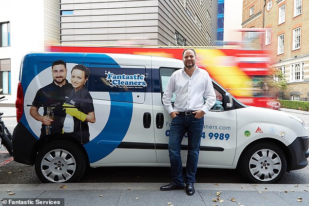 Rune stands in front of a van with Fantastic Services branding. He's on a mission to create 1,000 millionaires through his franchise business