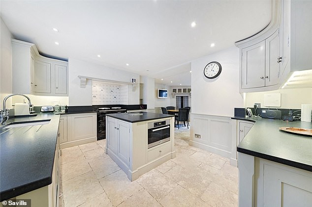 The modern kitchen on the lower ground floor boasts an Aga oven and seating area