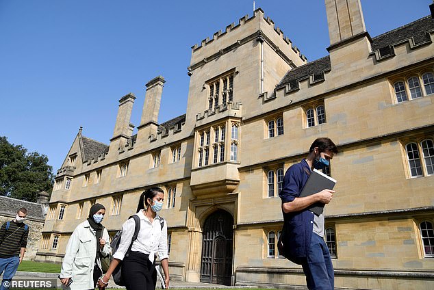 New normal: Students wear face masks outside Oxford University's Wadham College last month